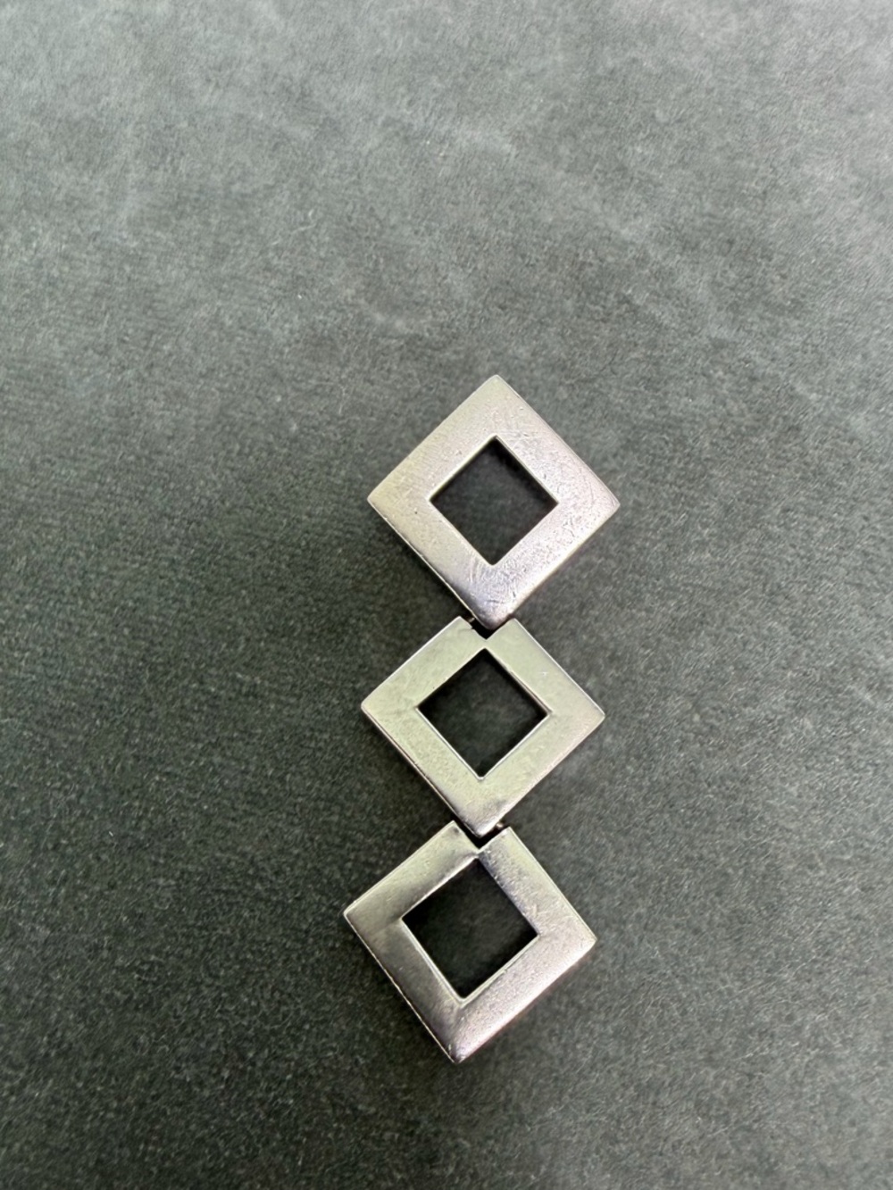 geometric sterling silver pendant featuring three interlocking open square links